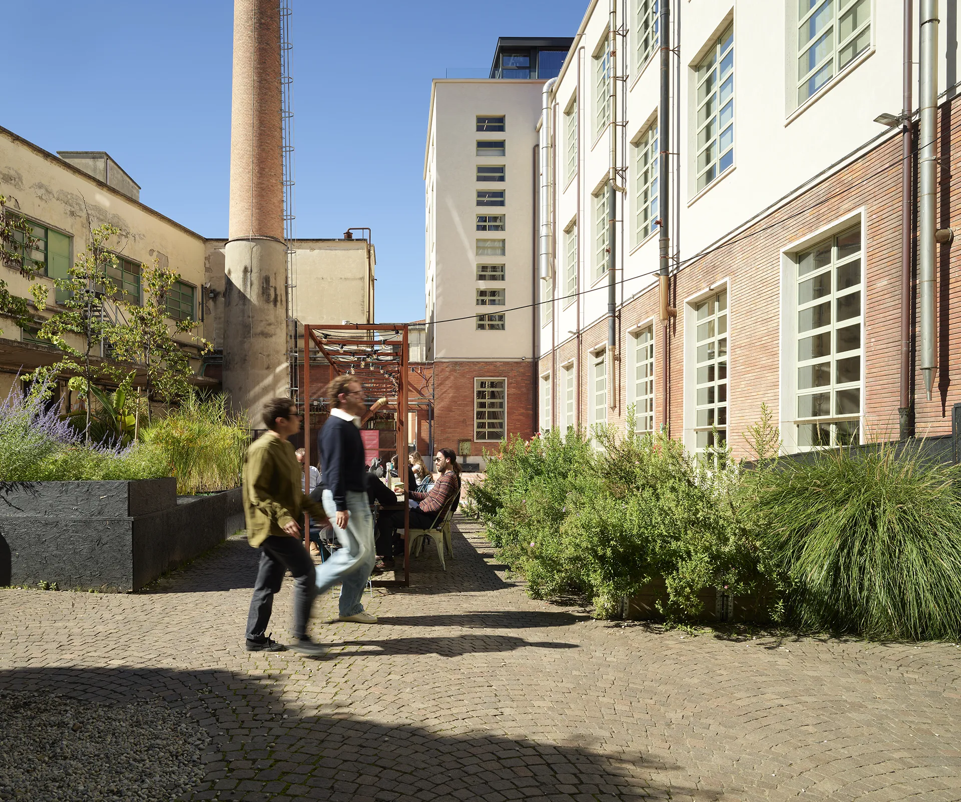 “Lifestyle atmosphere at Manifattura Tabacchi shaped by services and shared spaces”