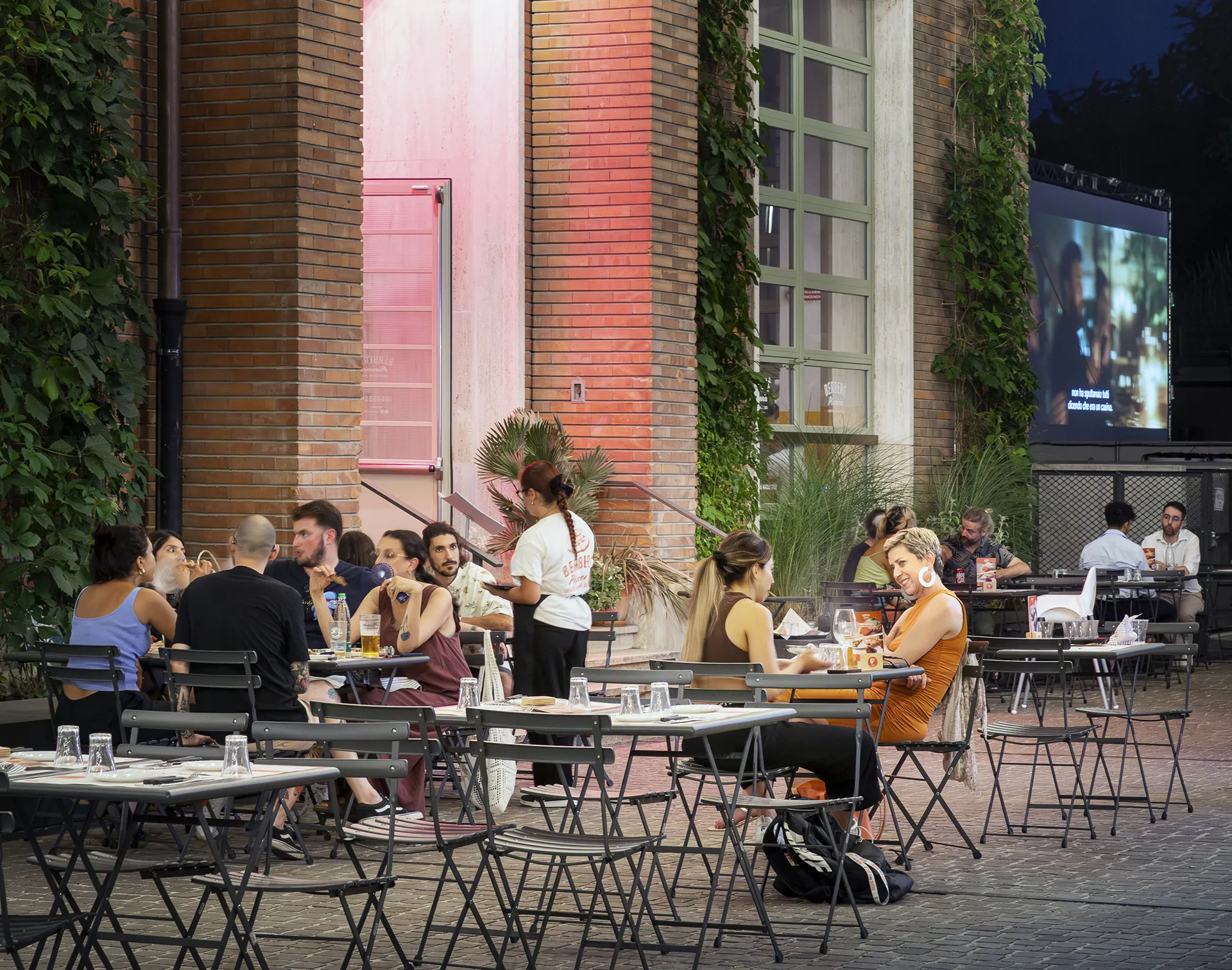 “People enjoying the urban spaces around Manifattura Tabacchi”